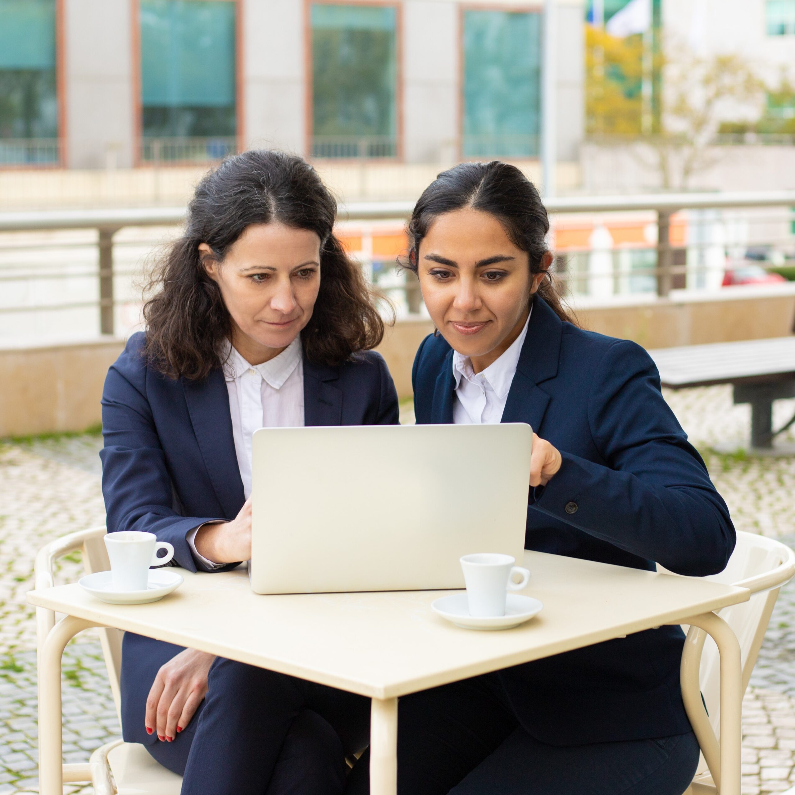 businesswomen with laptop outdoor cafe 1 scaled
